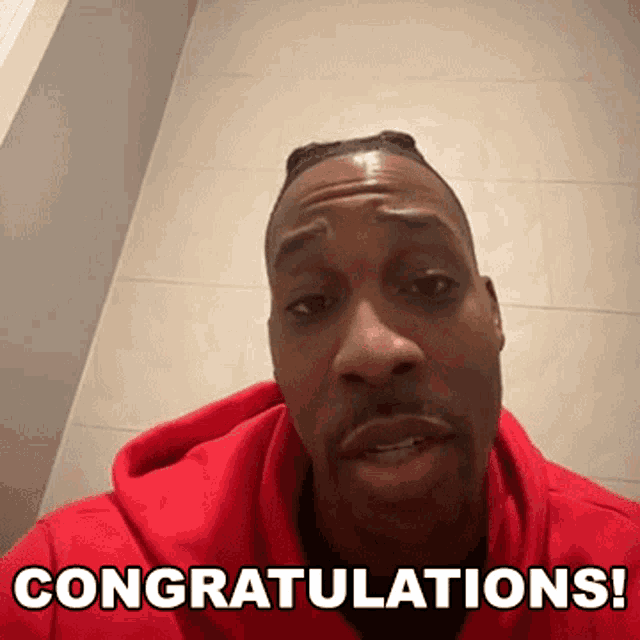 a man in a red hoodie is congratulating someone