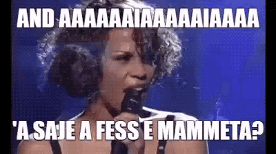 a woman singing into a microphone with a caption that says ' and aaa '
