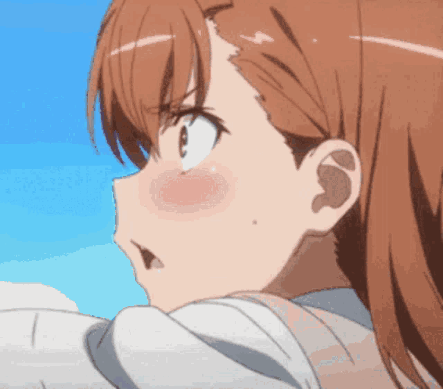 a close up of a girl 's face with her mouth open
