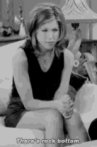 a woman is sitting on a couch and saying `` there 's rock bottom , '' .