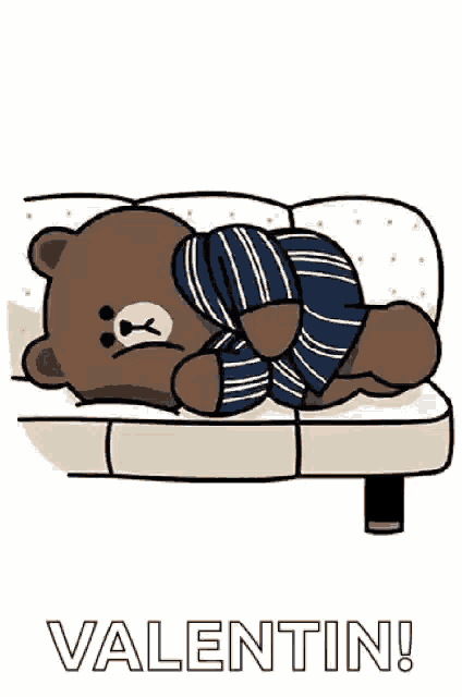 a brown teddy bear is laying on a couch wearing striped pants and socks .