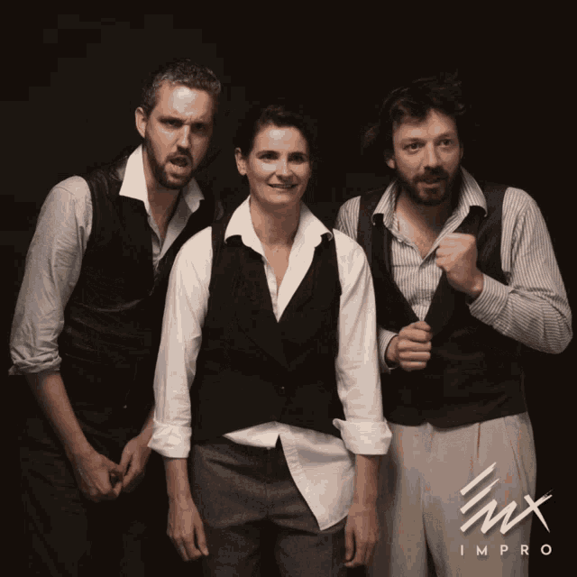 two men and a woman are posing for a photo with the word impro on the bottom right