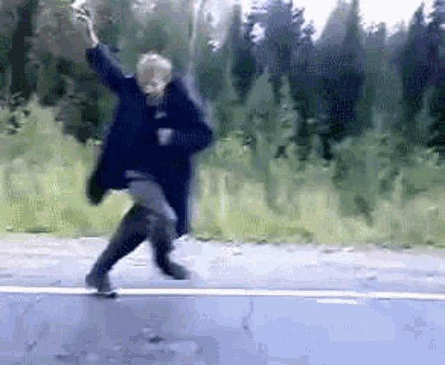 a person is dancing on the side of a road .