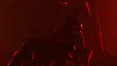 a red light is shining on a person 's face