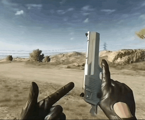 a person is holding a gun in their hand and pointing