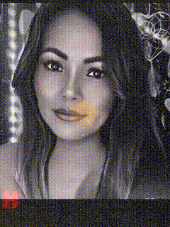 a close up of a woman 's face with a blurred background