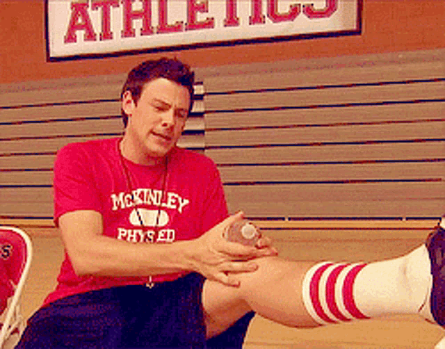 a man wearing a red shirt that says mckinley physical