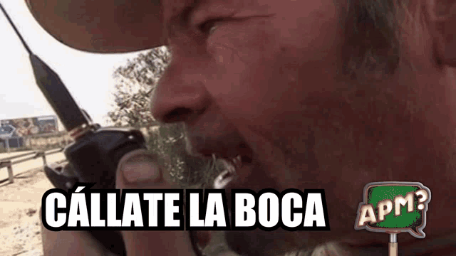 a man in a cowboy hat is talking on a walkie talkie with the words callate la boca written on the bottom