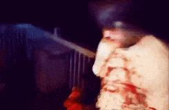 a blurry picture of a person with blood coming out of their chest .