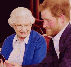 a man and an elderly woman are sitting next to each other and smiling .