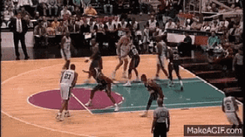 a basketball game is being played on a court with a referee .