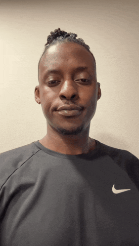 a man is wearing a black nike shirt