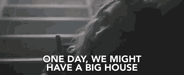 a woman laying on a set of stairs with the words " one day we might have a big house "