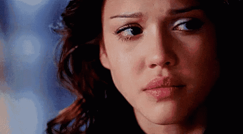 a close up of a woman 's face with tears coming out of her eyes .
