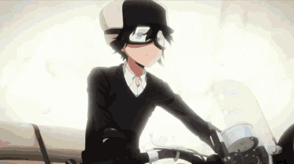 a young boy is riding a motorcycle with a helmet on .