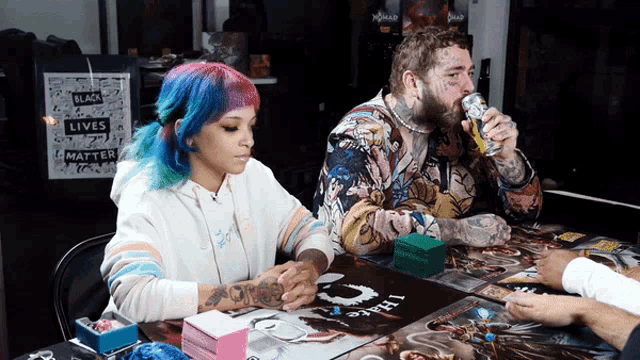 a group of people playing a game with a sign that says black lives matter in the background