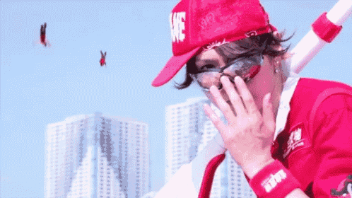 a person wearing a red hat that says " we " on it
