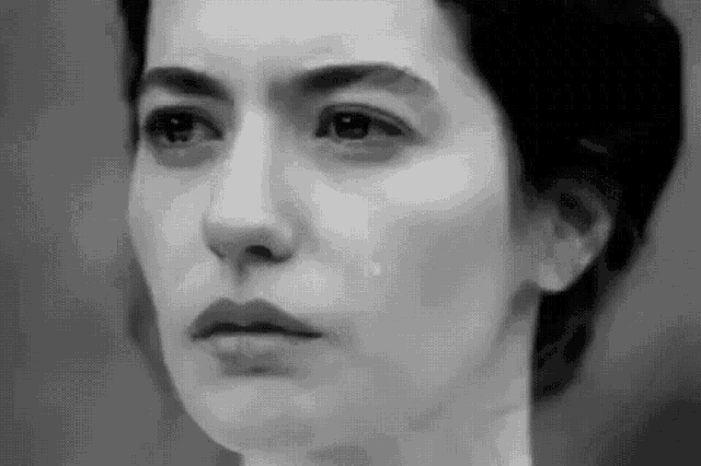 a woman is crying in a black and white photo .