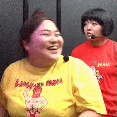 a woman wearing a yellow shirt that says laugh and peace is laughing