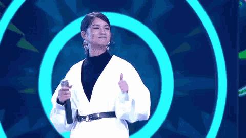 a woman giving a thumbs up in front of a blue circle