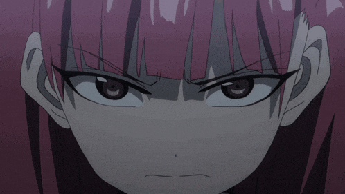 a close up of a person 's face with a serious look on their face
