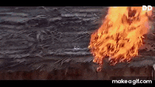 a large fire is coming out of a hole in the ground