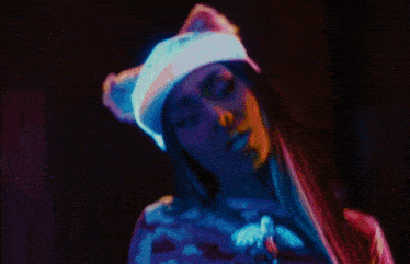 a woman wearing a cat ear hat and a ny hat