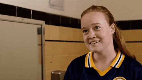 a girl wearing a blue and yellow shirt with the word miller on the front