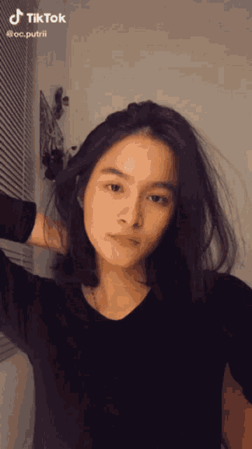 a woman is taking a selfie with a tiktok account