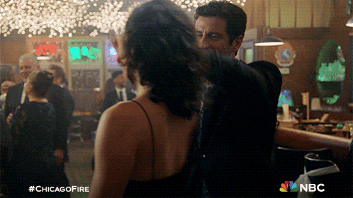 a man and woman are dancing in a bar with the hashtag #chicagofire on the bottom