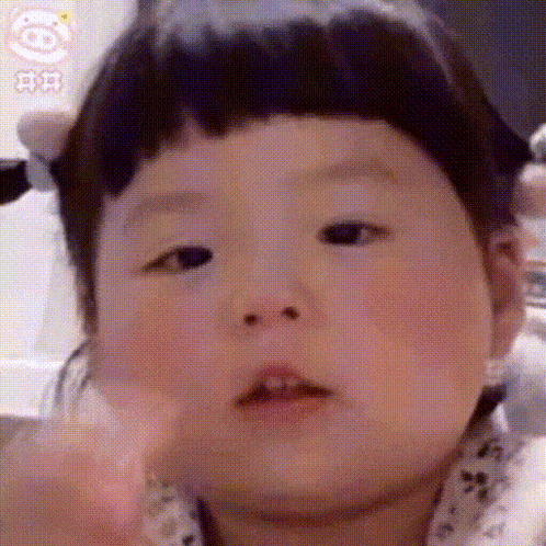 a close up of a baby making a face .