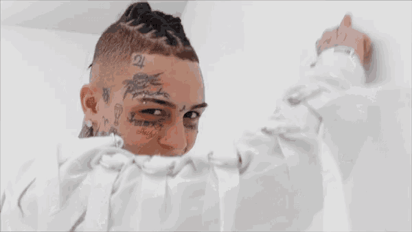a young man with tattoos on his face including one that says " always "