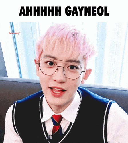 a young man with pink hair is wearing glasses and a vest