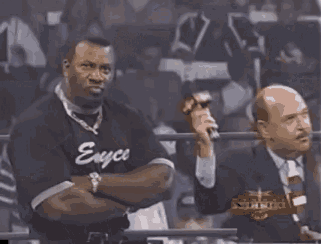 a man wearing a shirt that says enyce stands in a crowd