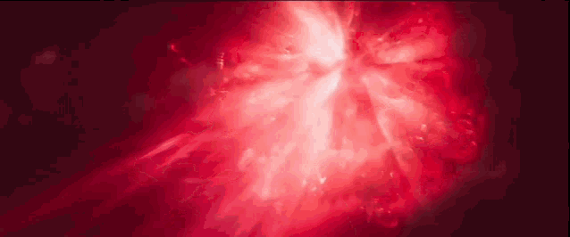 a close up of a red light coming out of a hole in the ground