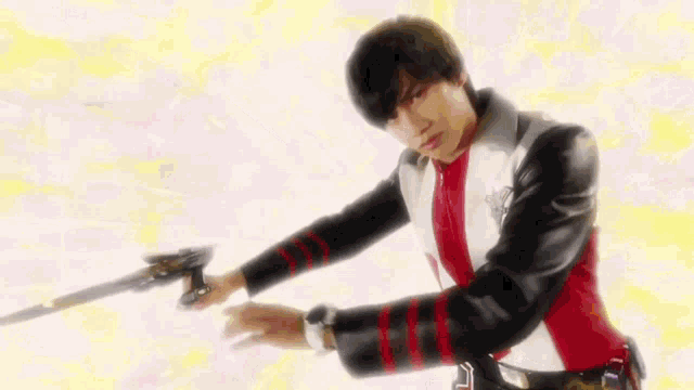 a young man is holding a sword in his hand .
