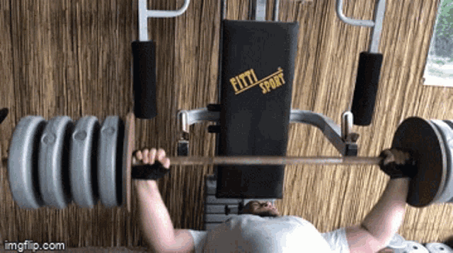 a man is lifting a barbell on a bench that says fifty sport