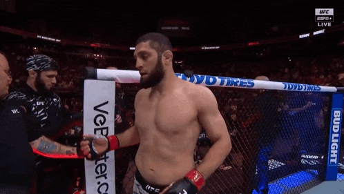 a man in a boxing ring with a sign that says bud light