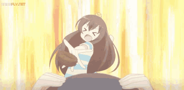 a girl with long brown hair and a crown on her head is standing in front of a man 's head .