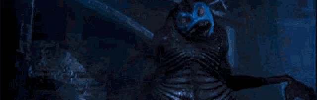 a monster with horns is standing in a blue room .