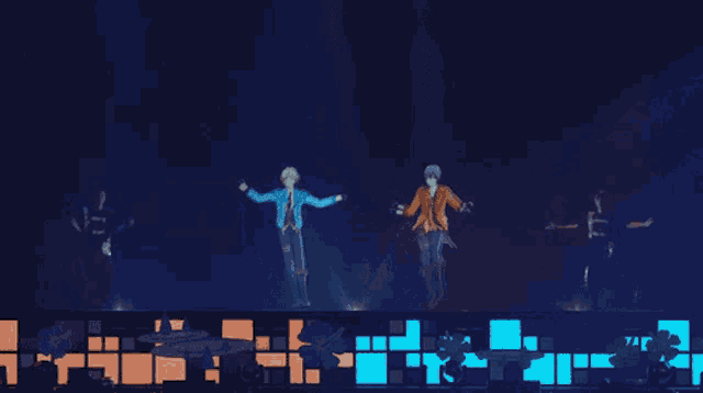 a group of people are dancing on a stage in front of a blue light