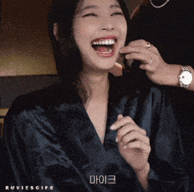 a woman in a black robe is laughing with the word ruvies gifs written below her
