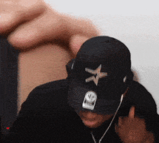 a man wearing a black hat with a white star on it