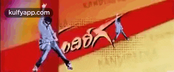 a man is jumping in the air in front of a sign that says ' kulfyapp.com ' on it .