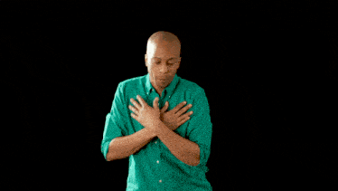 a woman in a yellow sweater touches a man 's shoulder