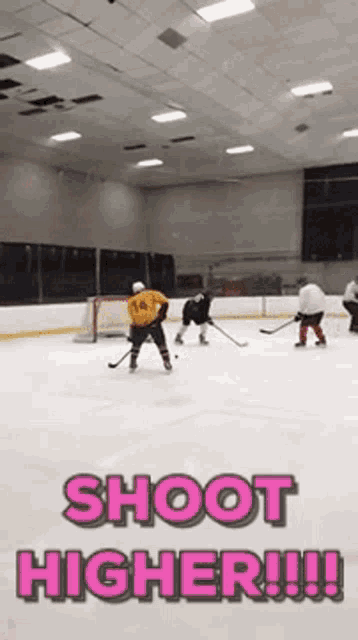 a hockey game is being played with the words shoot higher written in pink