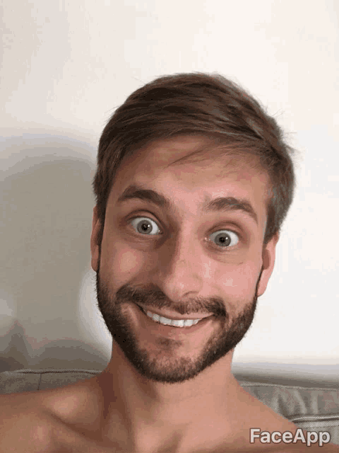 a shirtless man with a beard is smiling for the camera with faceapp written below him