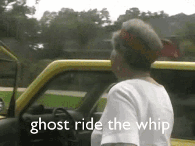 a woman is standing in front of a yellow car with the words ghost ride the whip written on it