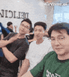 a group of young men are posing for a picture in front of a sign that says difficulty .