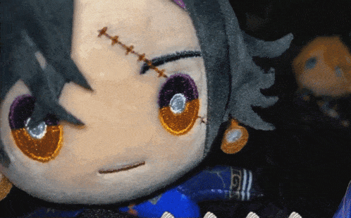 a stuffed animal with stitches on its face